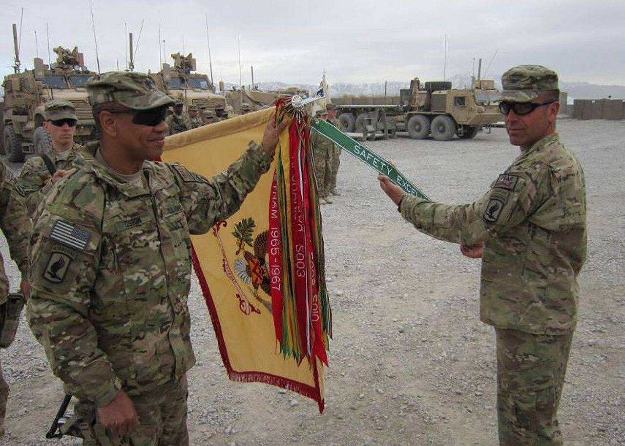 Photograph released by the DoD of the 173rd Brigade Support Battalion’s regimental streamers. The streamers of a specific unit or regiment may differ from the complete set of their commanding branch, depending on which battles the unit itself participated in. Notice the multiple copies of the all-red Meritorious Unit Commendation Streamer, all inscribed with different actions and years.