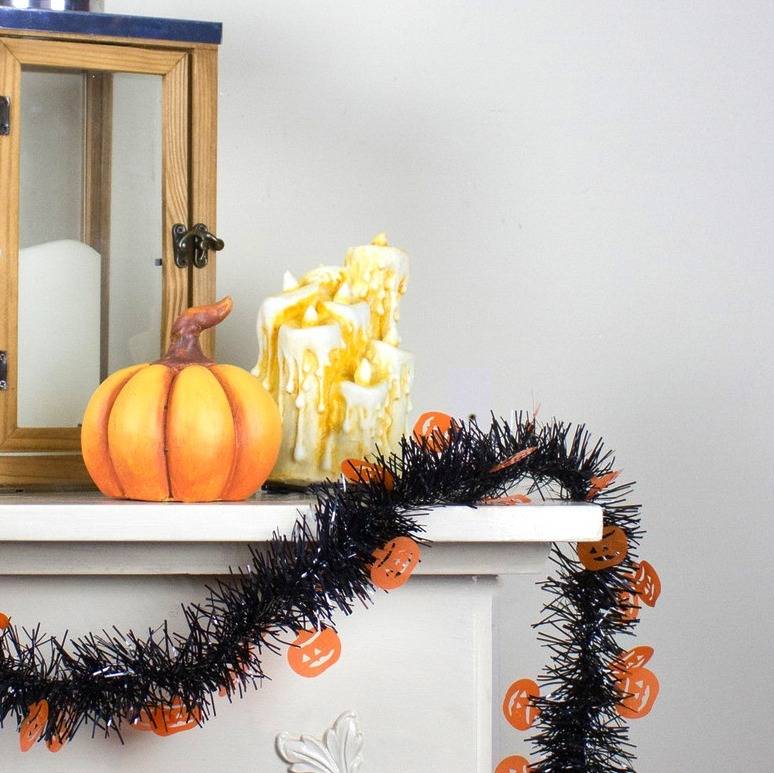 black tinsel garland with orange pumpkins
