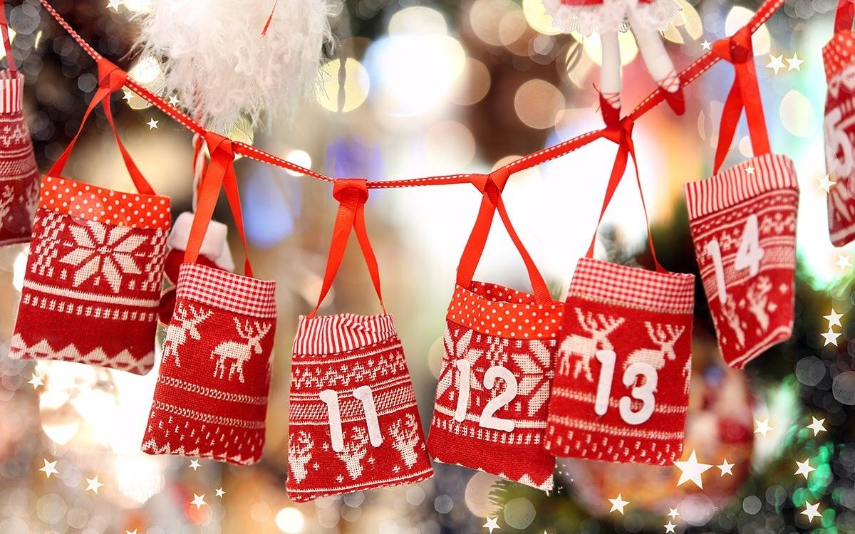 red and white numbered bags hanging on ribbons from Christmas Advent garland