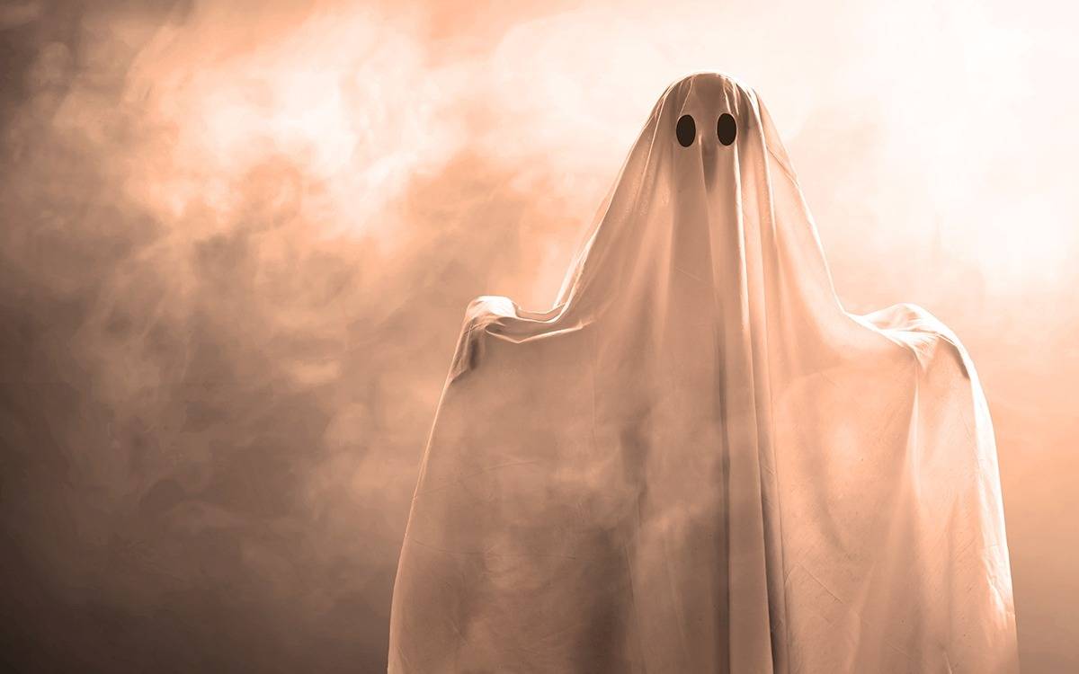 sheet-like ghost with black eyes in smoky, foggy space