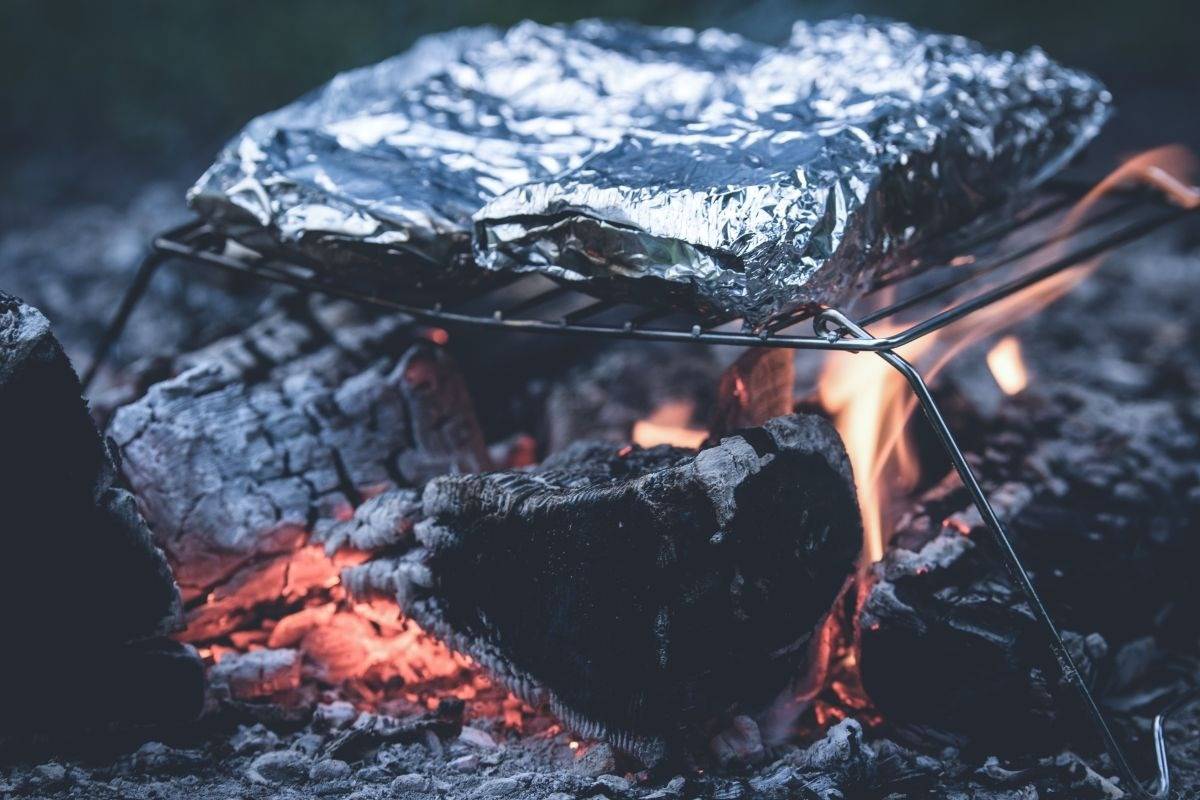 Foil packet meal over campfire