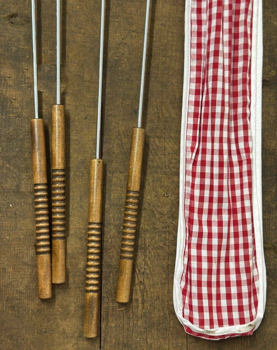 Long handled metal cooking forks with wooden handles and gingham carry bag