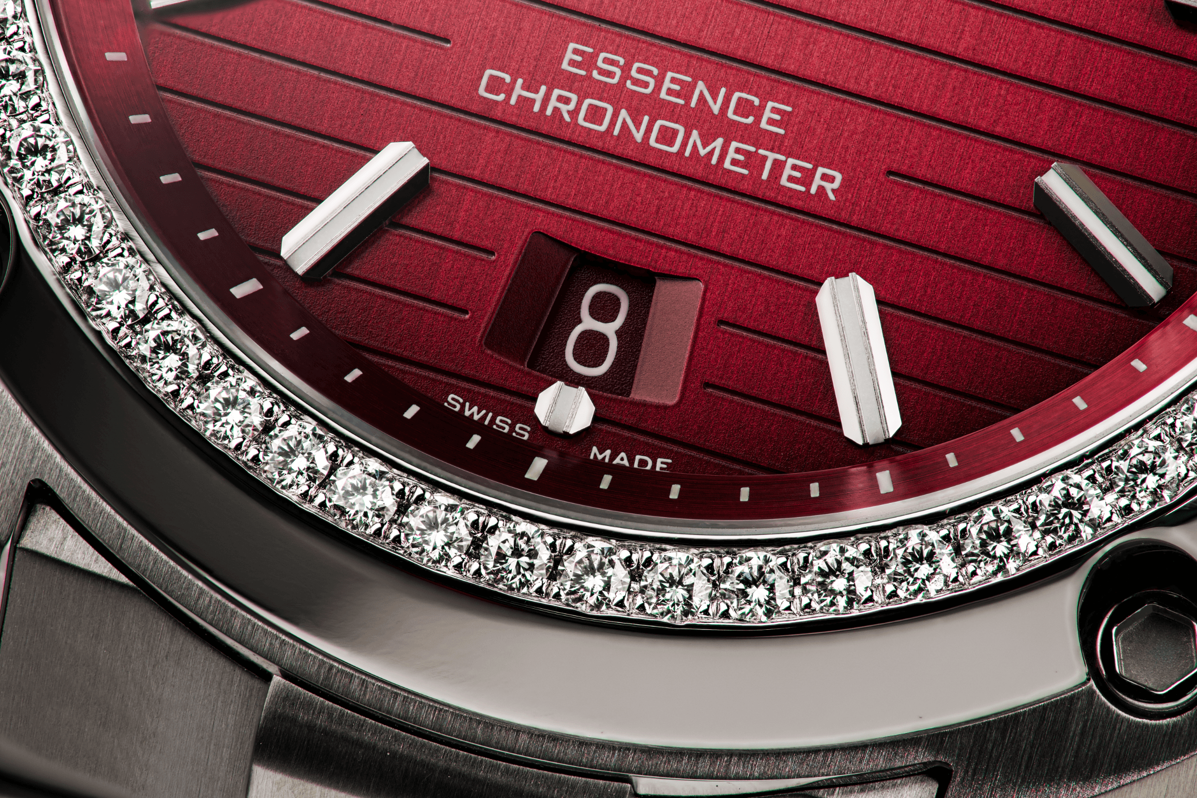 Formex Essence with red dial and diamond-set bezel on a dark background